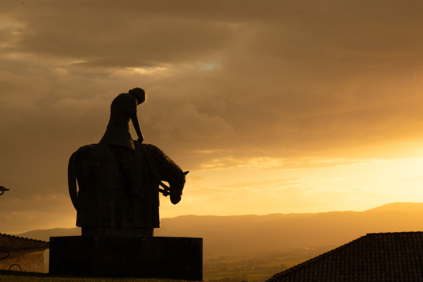 La statua di San Francesco dell'Autore Norberto al tramonto ad Assisi